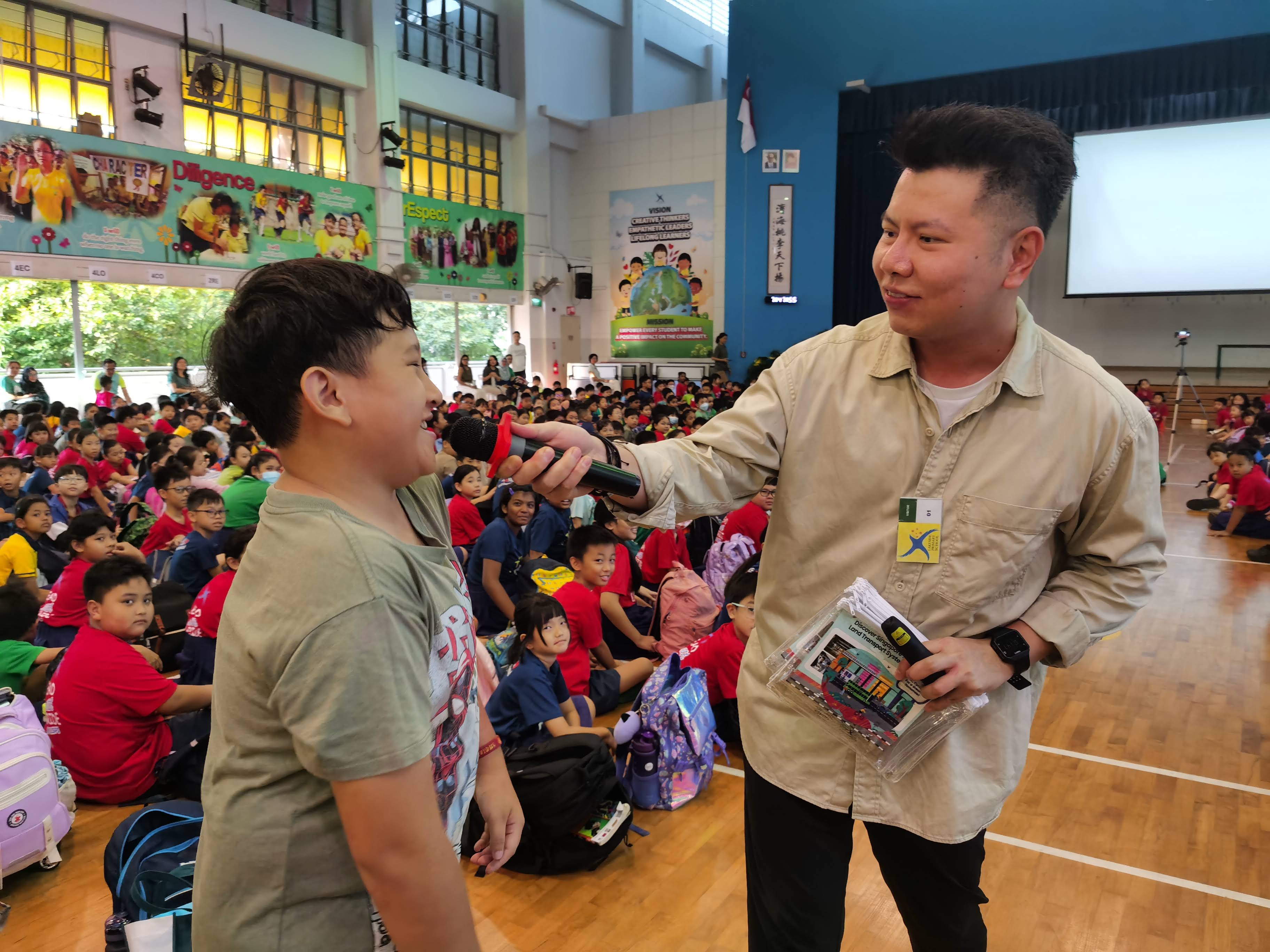 A lively discussion about sustainability during assembly between the hosts and the students